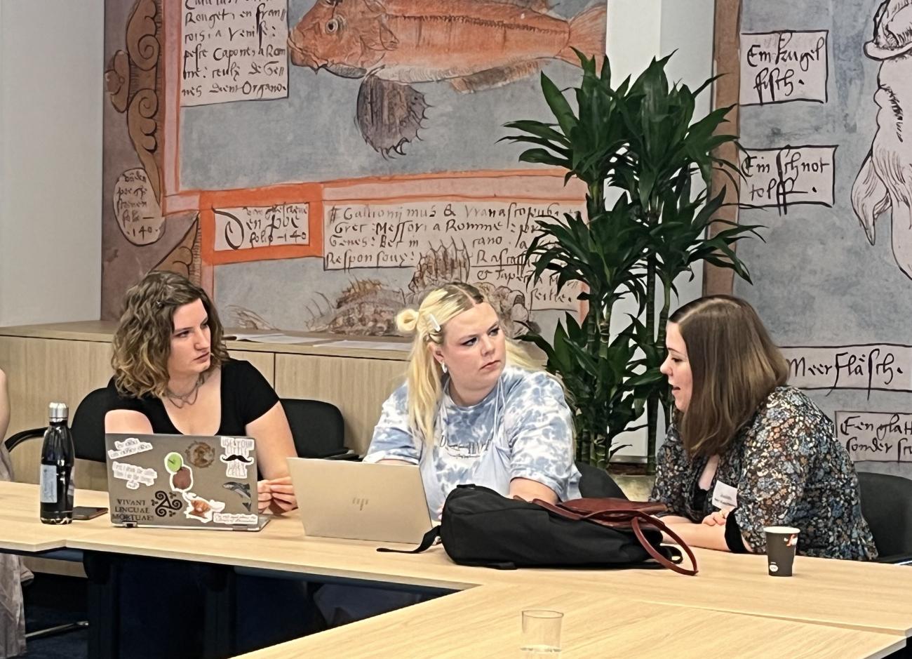 Group of three young woman discussing.