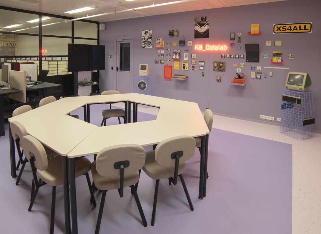 KB_Datalab room showing tables and chairs in a circle, work stations and the media wall